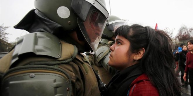 A demonstrator looks at a riot policeman during a protest marking the country s 1973 military coup in Santiago  Chile September 11  2016  REUTERS Carlos Vera FOR EDITORIAL USE ONLY  NO RESALES  NO ARCHIVE      TPX IMAGES OF THE DAY