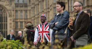 TOPSHOT - A man wearing clothing featuring the Union flag stands in front of the Houses of Parliament in London  on March 29  2017  shortly before British Prime Minister Theresa May announced to the House of Commons that Article 50 of the Lisbon Treaty had been triggered  formally starting Britain s withdrawl from the European Union  EU    Britain formally launched the process for leaving the European Union on March 29  a historic move that has split the country and thrown into question the future of the European project    AFP PHOTO   OLI SCARFF