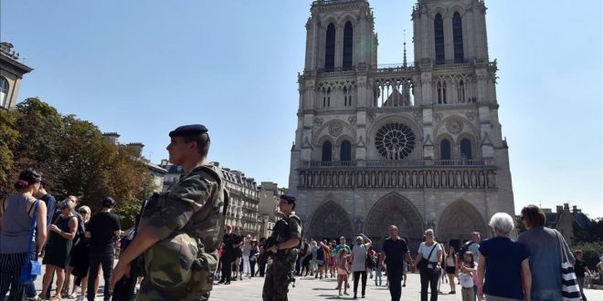 FILES  This file photo taken on August 15  2016 shows French soldiers patrolling in front of Notre Dame cathedral in Paris as part of the Sentinelle military force security mission while people queue for the mass for the feast of the Assumption on August 15  2016  French anti-terror police were holding two suspects on September 7  2016 after finding several gas cylinders in a car near Paris s Notre Dame cathedral  sources close to the investigation said  No detonators were found in the vehicle  which was discovered abandoned at the weekend  September 3 and 4  2016   the sources said  The car s owner and an associate  both known to police  were arrested on September 6  2016 they said  adding a preliminary investigation had been launched    AFP PHOTO   ALAIN JOCARD