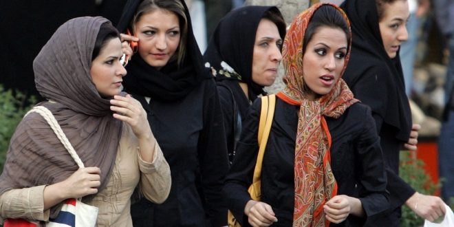 Iranian women walk in a street in Tehran 23 April 2007  The police bus screeches to a halt at a Tehran square packed with traffic  The officers leap out and begin spot checks on passing pedestrians and cars  Police work apparently like any other place in the world  But here in the Iranian capital their targets are women deemed to have infringed the Islamic republic s strict dress rules  AFP PHOTO ATTA KENARE